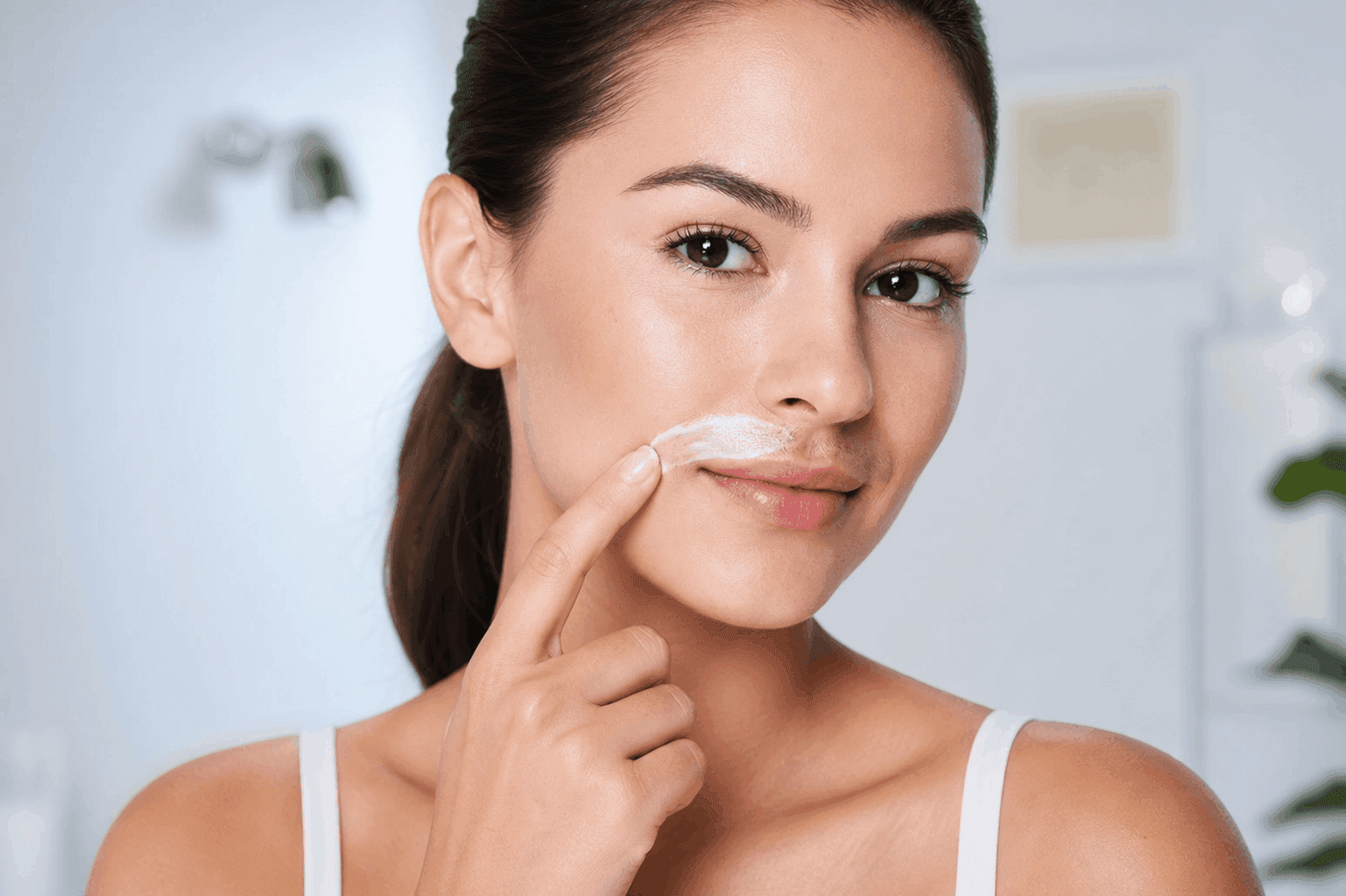 Woman applying hair reduction treatment to her upper lip
