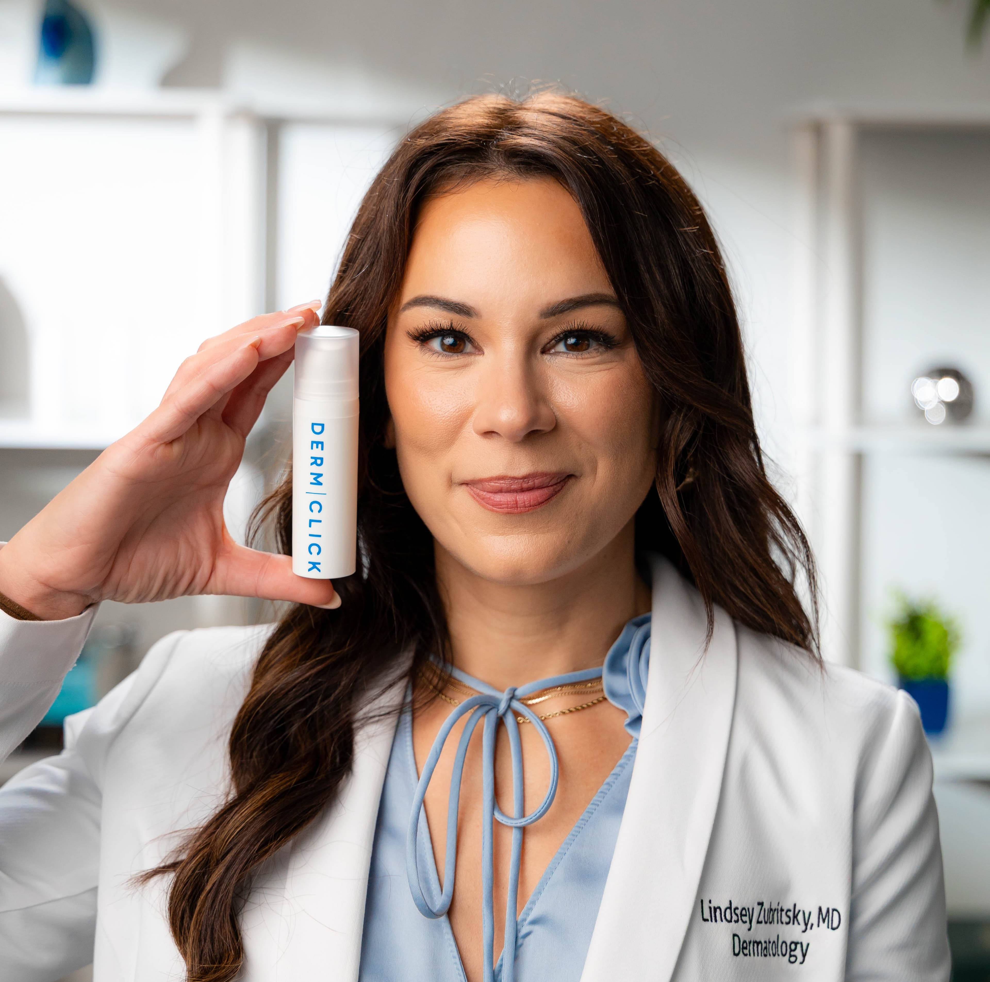 Dr. Lindsey Zubritsky holding a DermClick tretinoin formula
