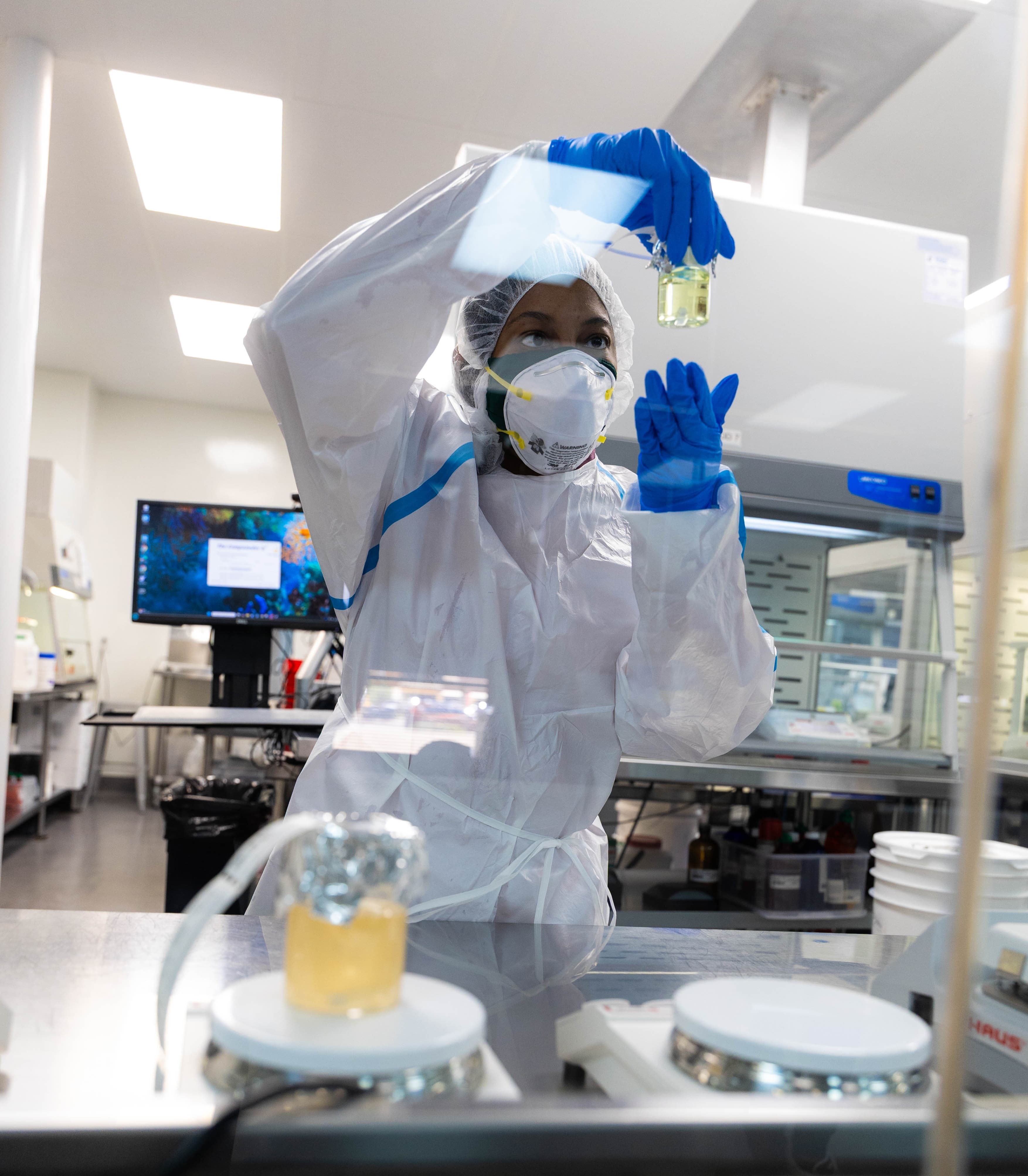 A DermClick pharmacist inspecting a compounded tretinoin formula in the lab